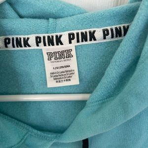 Aqua blue hoodie with drawstring.